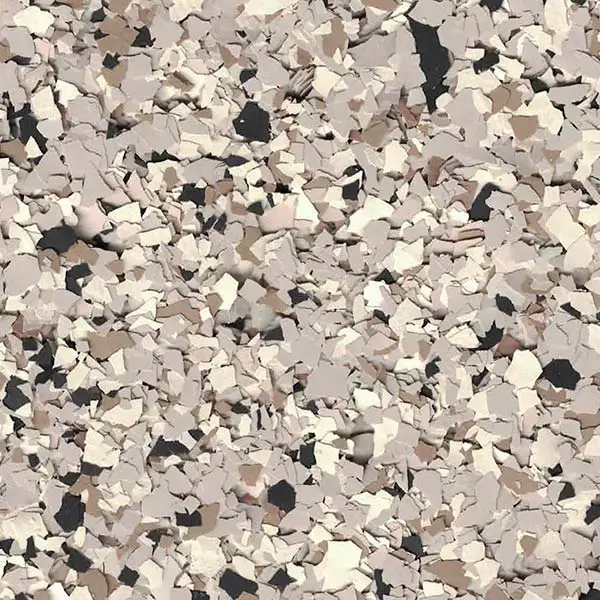 The image shows a textured surface with scattered pieces in shades of beige, gray, and black, resembling stone or mosaic fragments.