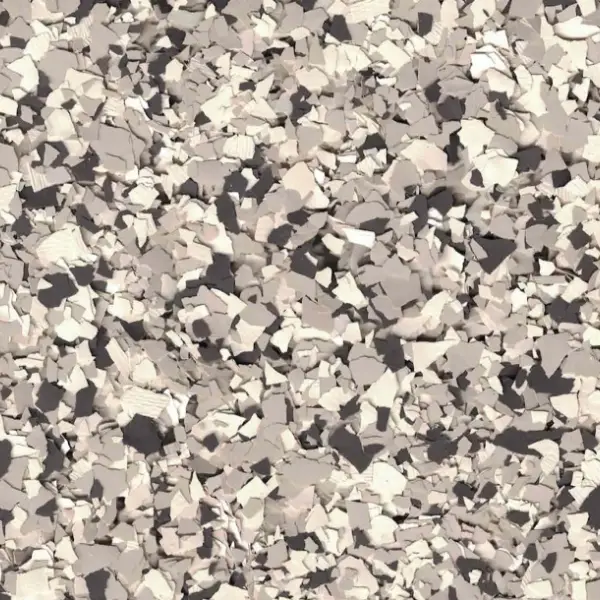 Abstract image depicting scattered, overlapping gray and beige flakes or shards, resembling broken stone or concrete fragments against a neutral background.