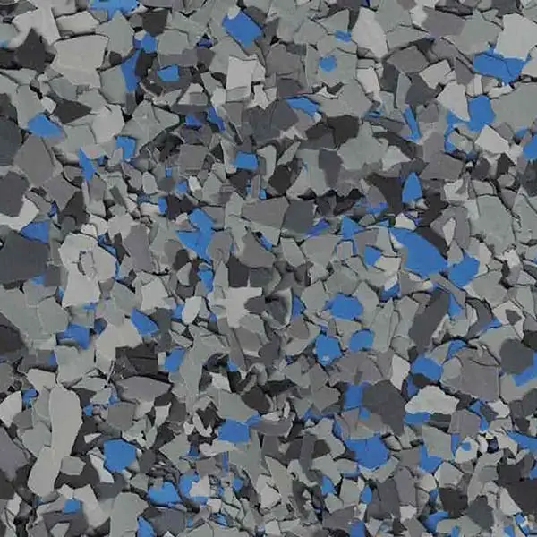 An abstract close-up image of multi-colored flakes in gray and blue tones, creating a textured and layered visual effect.